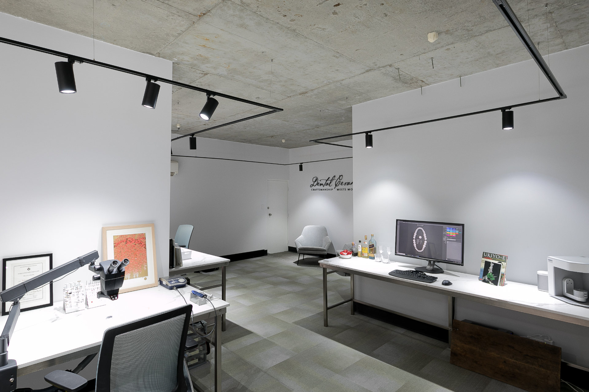 Wide view of the studio floor with workstations and the studio signage on the back wall